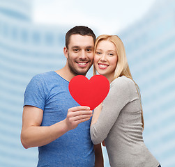 Image showing smiling couple holding big red heart