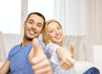 Image showing smiling happy couple at home showing thumbs up