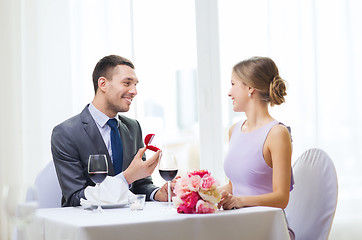 Image showing man proposing to his girlfriend at restaurant