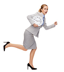 Image showing stressed young businesswoman with clock running