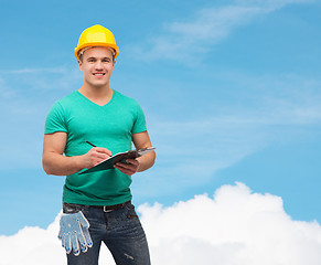 Image showing smiling man in helmet with clipboard