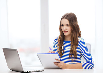 Image showing teenage girl laptop computer and notebook