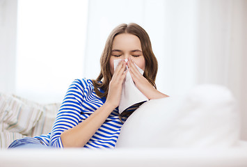 Image showing sick teenage girl with paper tissue