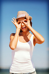 Image showing girl making funny faces on the beach