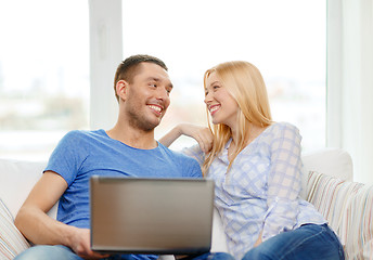 Image showing smiling happy couple with laptop at home