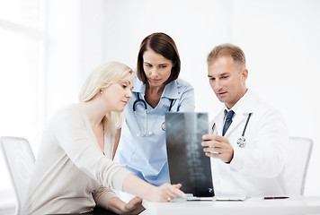 Image showing doctors with patient looking at x-ray