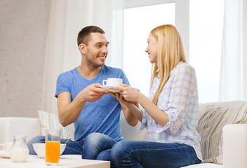 Image showing man giving his girlfriend or wife cup of coffee