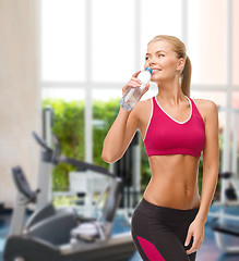 Image showing smiling woman with bottle of water