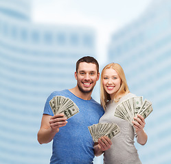 Image showing smiling couple holding dollar cash money