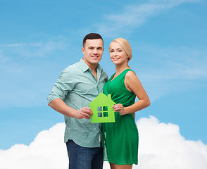 Image showing smiling couple holding green paper house