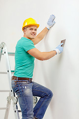 Image showing smiling man in helmet doing renovations at home