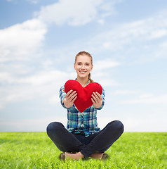 Image showing young woman in casual clothes sitting on floor