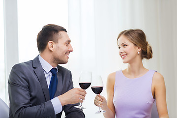 Image showing young couple with glasses of wine at restaurant