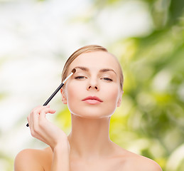 Image showing beautiful woman with makeup brush