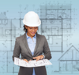 Image showing businesswoman in white helmet with blueprint