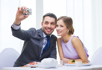 Image showing smiling couple taking self portrait picture