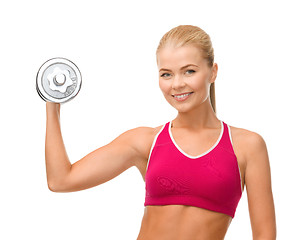 Image showing smiling woman with heavy steel dumbbell