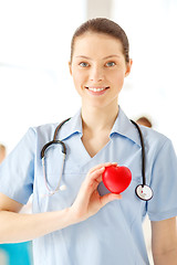 Image showing smiling female doctor with heart an stethoscope