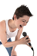 Image showing Woman singing into a microphone