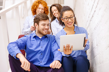 Image showing team with tablet pc computer sitting on staircase