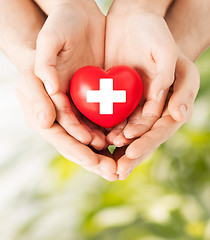 Image showing male and female hands with red heart