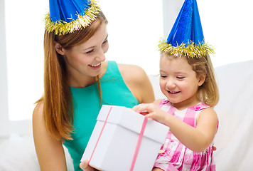 Image showing mother and daughter in blue hats with gift box