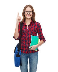 Image showing smiling female student with bag and notebooks