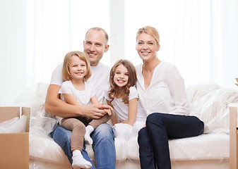 Image showing smiling parents and two little girls at new home