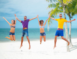 Image showing group of friends or couples jumping on the beach