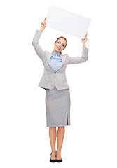 Image showing smiling businesswoman with white blank board