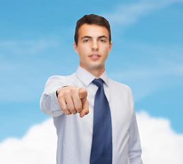 Image showing friendly young buisnessman pointing finger