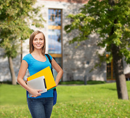 Image showing smiling student with bag, folders and tablet pc