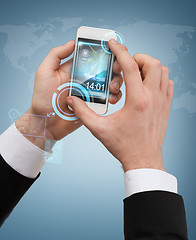 Image showing businessman touching screen of smartphone