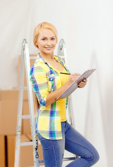 Image showing smiling woman with clipboard