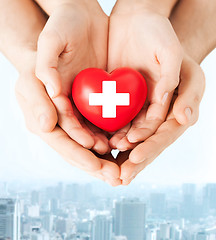 Image showing male and female hands with red heart