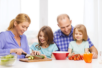 Image showing happy family with two kids making dinner at home