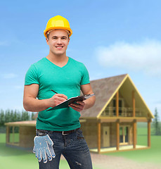 Image showing smiling man in helmet with clipboard