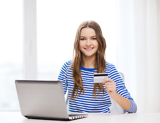 Image showing smiling teenage gitl with laptop computer at home