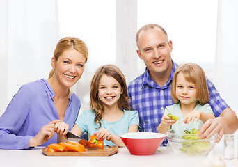 Image showing happy family with two kids making dinner at home