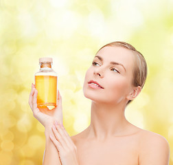 Image showing lovely woman with oil bottle