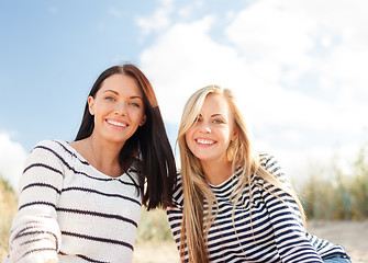 Image showing smiling girlfriends having fun on the beach