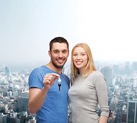 Image showing smiling couple holding keys