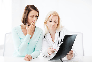 Image showing doctor with patient looking at x-ray