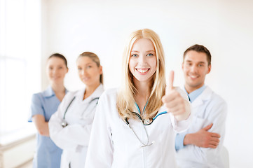 Image showing female doctor or nurse in front of medical group