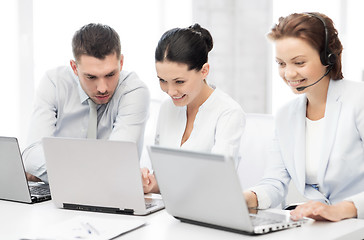 Image showing group of people working with laptops in office