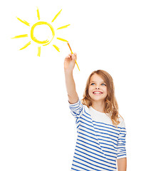 Image showing cute little girl drawing sun with brush