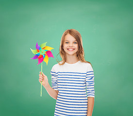 Image showing smiling child with colorful windmill toy