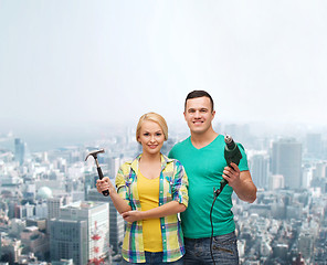 Image showing smiling couple with hammer and drill