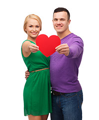 Image showing smiling couple holding big red heart