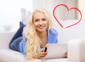 Image showing smiling woman with tablet pc computer at home